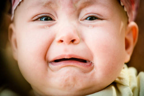 Baby crying - pure authentic emotion, tears visible